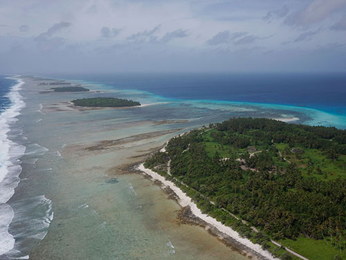 Aerial photograph of Kwajalein Atoll showing its low-lying islands and coral reefs.