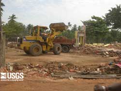 Bulldozers and front-end loaders redistributing the rubble and cleaning up debris in Hikkaduwa, Sri Lanka; seee caption below