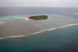 Aerial photograph of waves breaking on the fringing reef off Ennuebing Island, Kwajalein Atoll, Republic of the Marshall Islands.