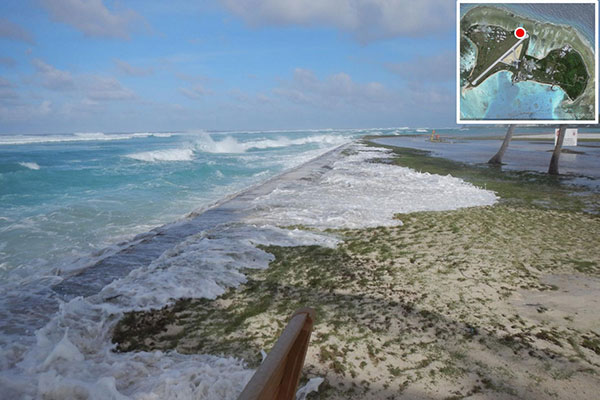 Photo taken March 2, 2014 during an overwash event in the Republic of the Marshall Islands showing seawater overtopping the manmade perimeter berm on the island of Roi-Namur and covering large areas of the adjacent land surface.