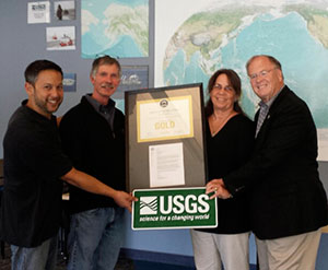 Left to right, William Ow, Ow Properties, Bob Rosenbauer, USGS Pacific Coastal and Marine Science Center Director, Jane Reid, Deputy Center Director, and Congressman Sam Farr hold plaque and letter commemorating LEED Gold Award given to the USGS center in 2013.