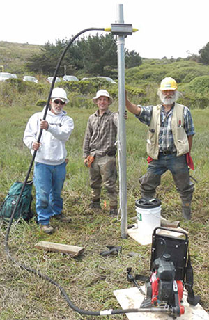 Scientists collecting sediment samples at Pillar Point, California, with a vibracorer