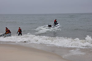 Tim Elfers, far left, of the Pacific Coastal and Marine Science Center, completes a beach launch of instrumented personal watercraft at Fire Island with USGS colleagues.