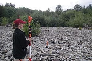 Before dam removal, Amy East (then Amy Draut) surveys along the Elwha River in March 2007. USGS photograph by Joshua Logan.