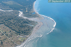 Aerial photograph of the Elwha River mouth during dam removal, showing the expansion of the river mouth delta by sediment deposition; photo by Neal and Linda Chism, volunteers with LightHawk.