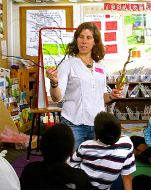 Photograph of oceanographer Nancy Prouty showing deep-sea corals to 2nd graders.