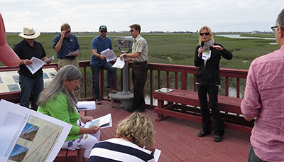 Photograph of Li Erikson speaking to Congressional staffers at an estuary near Seal Beach in southern California.