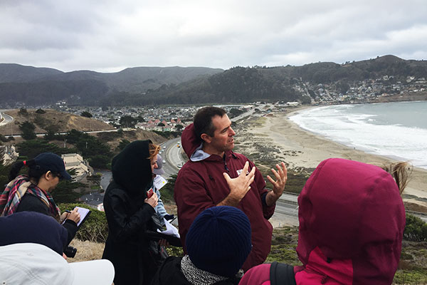 Patrick Barnard and field trip participants above Pacifica State Beach, where future large storms combined with sea-level rise could flood parts of the highway and other infrastructure.