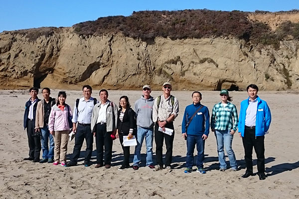 Chinese visitors and USGS hosts during a field trip stop at Cove Beach in Ao Nuevo State Park. Photo by Stephen Hartwell, USGS.
