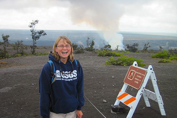 Amy East wears her -I love geology- face as Hawaii's Kilauea volcano steams in the background. Photo by Erin Todd, USGS.