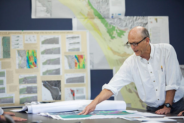 Geophysicist Samuel Johnson checks out the new maps at the USGS Marine Geology Mapping center, Thursday, June 11, 2015, in Santa Cruz, Calif.
