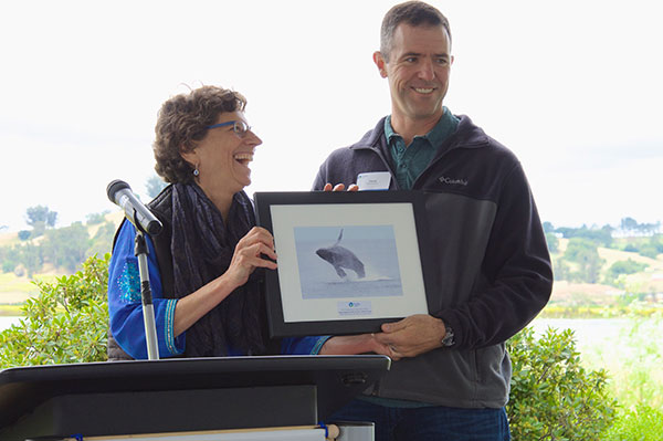 Photograph of Patrick Barnard receiving the Point Blue award from Point Blue Conservation Science President and CEO Ellie Cohen. Photo by Cathy Summa-Wolfe.