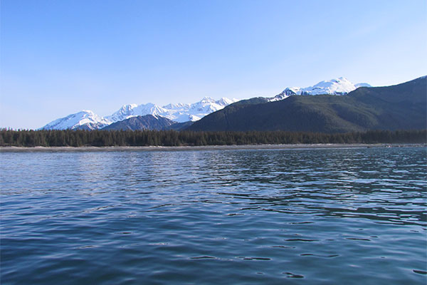 Photograph looking north toward the Fairweather Range during 2015 mapping of the Queen Charlotte-Fairweather fault off Glacier Bay National Park and Preserve. The fault is directly beneath the vessel upon which the photographer, Danny Brothers, is standing.