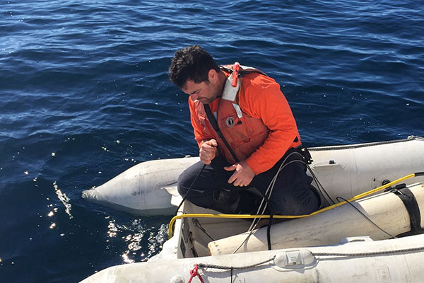 Pete Dal Ferro deploying the bubbler system from an inflatable vessel.