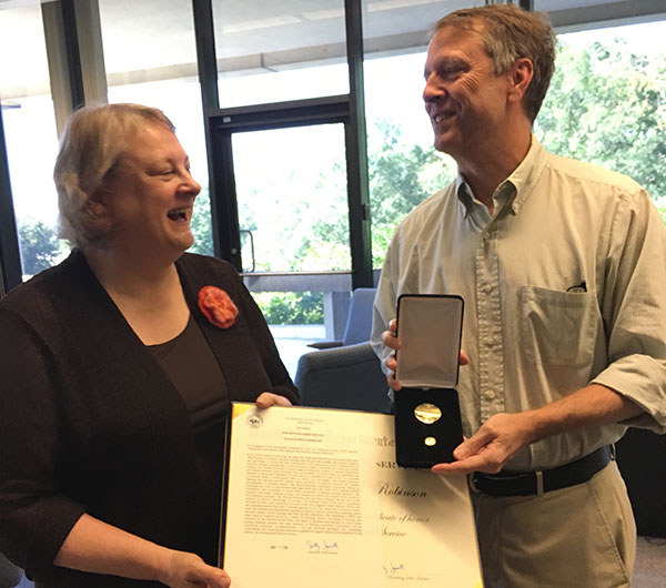 Susan Russell-Robinson receives the Department of the Interior's Distinguished Service Award from USGS Acting Associate Director John Haines.