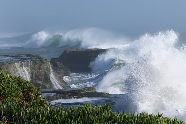 Large storm waves crashing on the rocks near Santa Cruz, California. Photo by Christie Hegermiller, USGS