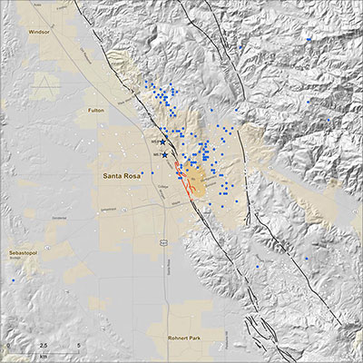 Gray-shaded map of Santa Rosa, California, black and red lines show the traces of active faults, stars show epicenters of damaging earthquakes in 1969, and little circles show small earthquake epicenters.