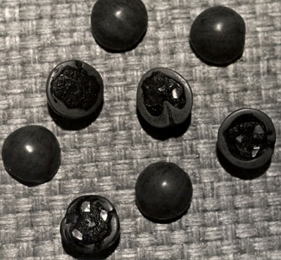 Photo of walnut-shell dice.