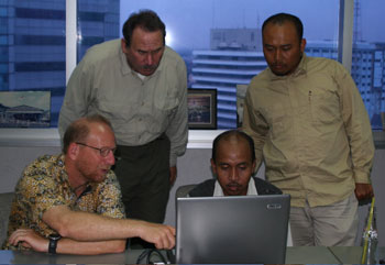 Photo of members of ITST reviewing data on the computer