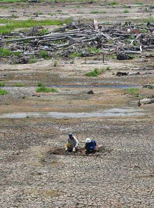 Photo, Widjo and Hig examining tsunami sand deposits