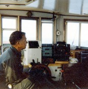 Captain Arthur D. ("Dick") Colburn (WHOI) in his customary position at the helm of the RV Asterias during cruise AST 81-2.