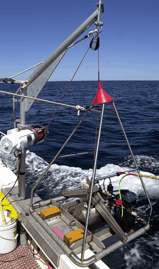 Photograph of small U.S. Geological Survey SeaBed Observation and Sampling System (SEABOSS) being deployed at sea.