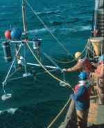 Figure 4C.   A small tripod frame, about 1.5 m high, being deployed at a site in Massachusetts Bay.  