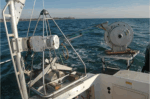 Figure 13. View of the small SEABOSS, a modified Van Veen grab sampler equipped with still and video photographic systems, mounted on the aft starboard side of the research vessel Rafael.
